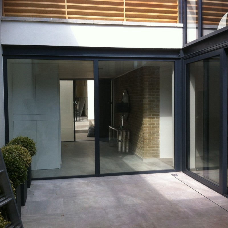 Floor-to-ceiling sliding doors opening to courtyard in Hither Green