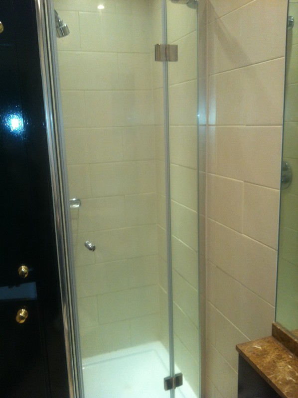 Frameless glass shower enclosure with chrome fittings in Hither Green