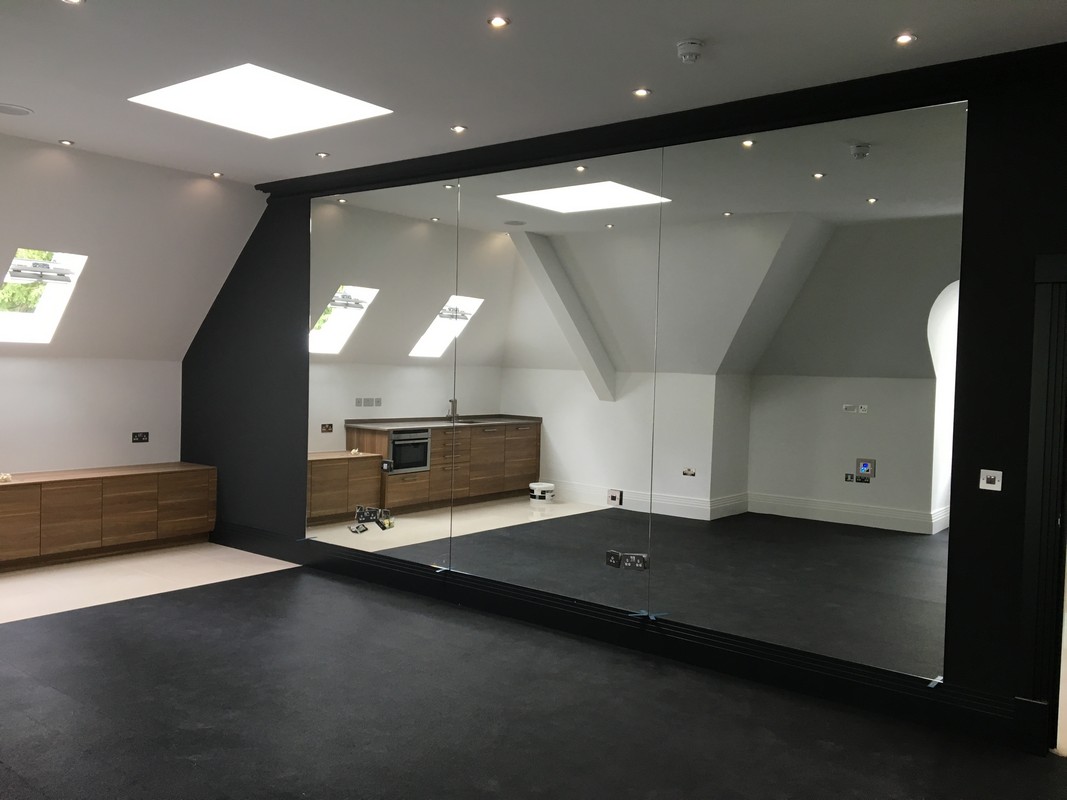 Frameless glass wall dividing loft conversion in Hither Green